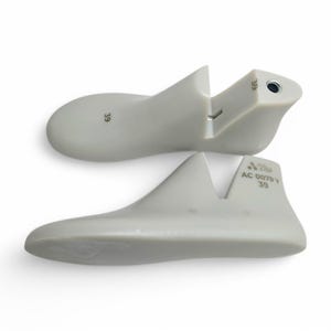 May include: Two light gray shoe lasts, size 39, are displayed against a white background. The lasts are made of a smooth material and are designed to maintain the shape of shoes. One last is split at the heel.