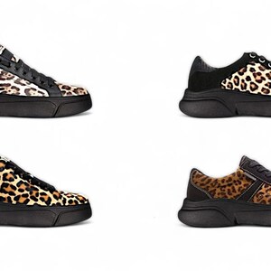 May include: Four pairs of black and brown leopard print sneakers with white accents. The sneakers have a chunky platform sole.