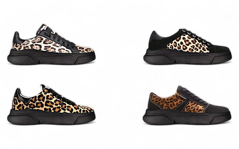 May include: Four pairs of black and brown leopard print sneakers with white accents. The sneakers have a chunky platform sole.