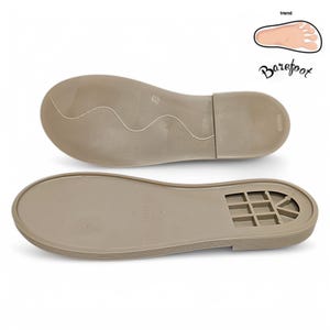 May include: Two beige shoe soles are displayed against a white background. The top sole has a textured, wavy pattern, while the bottom sole features a grid-like design. The word "Barefoot" is written in cursive, with a foot graphic.