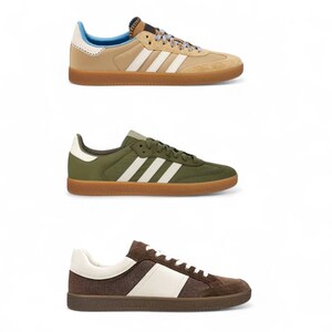 May include: Three pairs of Adidas Samba sneakers in different color schemes. The top pair is tan with white stripes and a brown sole. The middle pair is olive green with white stripes and a brown sole. The bottom pair is brown with white accents and a brown sole.