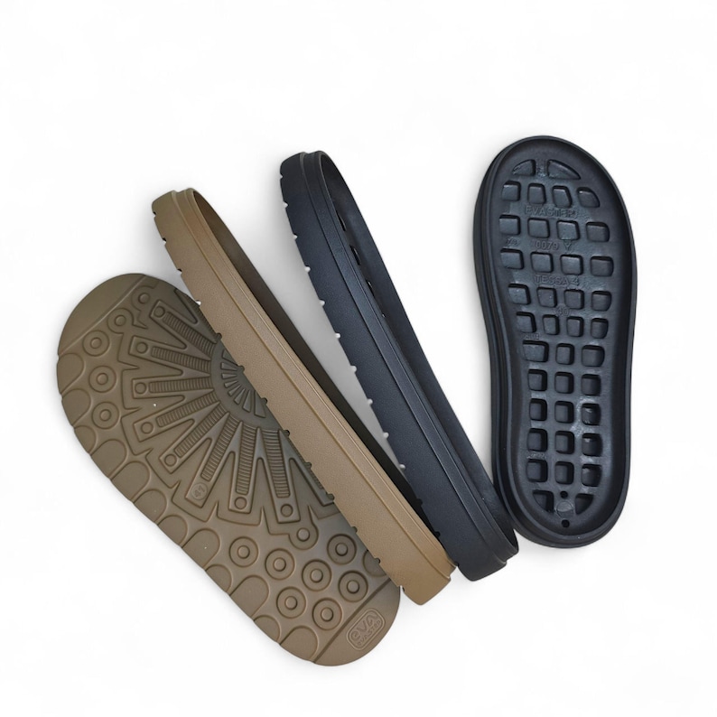 May include: Four shoe soles in shades of brown and black are arranged against a white background. The soles have various tread patterns, including a circular design and a grid of rectangular shapes. The materials appear to be rubber or a similar synthetic.