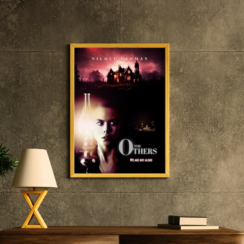 May include: A movie poster for the film "The Others" starring Nicole Kidman. The poster features a woman holding a lantern in front of a dark, ominous house. The text on the poster reads "The Others" and "We are not alone."