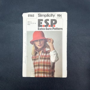 May include: Simplicity sewing pattern number 8165, ESP Extra-Sure Pattern, for a sleeveless vest with a plaid pattern and a red hat. The pattern is for sizes 12, 14, 16 for misses.