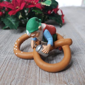 retired 1987 christmas ornament seasoned greetings hallmark keepsake collectible holiday decoration santas elf pretzel hanging decor 1980s