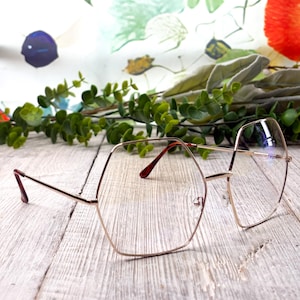 May include: A set of three ceramic mugs with a speckled, matte finish. The mugs are in shades of cream, light gray, and dark gray. Each mug has a simple, minimalist design and a rounded handle.