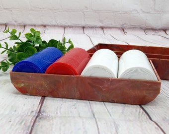 vintage poker chips in a marbled plastic chip caddy