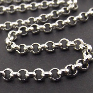 May include: A silver chain with a round, smooth link design. The chain is made of metal and has a polished finish.