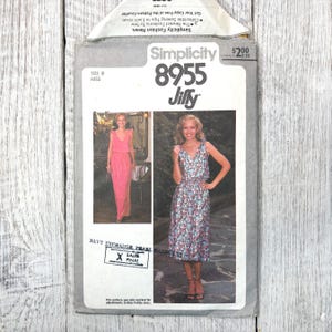 May include: Vintage Simplicity pattern 8955 for Misses' dresses. The pattern envelope features images of the finished dresses, a pink maxi dress and a floral print midi dress. The envelope is marked with a Navy Exchange Pearl Harbor stamp.