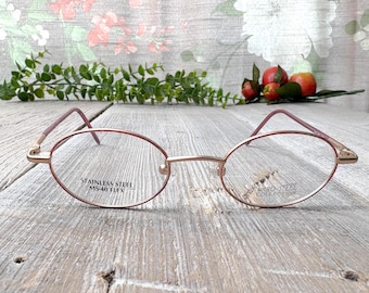Monturas de gafas ovaladas vintage: oro claro y oro rosa, años 90, sin usar.