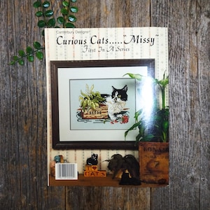 Curious Cats Missy cross-stitch pattern black and white kitten garden seeds wall hanging art decor embroidery embroidered how-to diy crafts