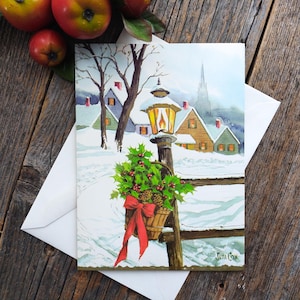 Winter Wonderland kerstkaart eigentijdse wenskaart lantaarnpaal hulst bladeren bessen dennenappels huizen sneeuwlandschap vintage briefpapier