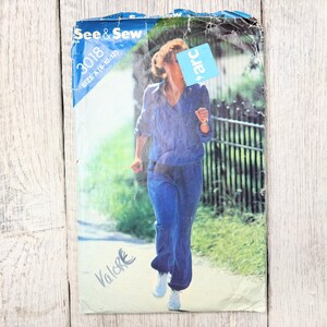 May include: Vintage sewing pattern titled "See & Sew 3018" featuring a woman in a blue jogging suit. The pattern cover shows the woman running on a path. The size is A (8-10-12). The word "Valore" is written on the bottom left.