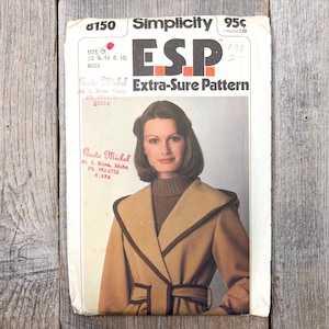 May include: Vintage Simplicity sewing pattern featuring a woman in a tan coat with brown trim. The pattern is labeled "ESP Extra-Sure Pattern" and includes the size range of 12, 14, and 16. The pattern cover has the text "Gusta Michel" and a phone number.