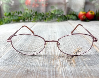 Monturas de gafas ovaladas vintage en oro rosa: moda unisex de los 90.