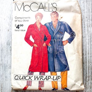 May include: A McCall's sewing pattern envelope titled QUICK WRAP-UP featuring illustrations of two individuals wearing long-sleeved, belted robes. One robe is red with striped trousers, and the other is blue with solid yellow trousers.