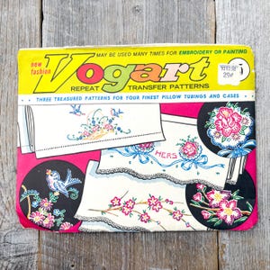 May include: Vintage Vogart transfer patterns for embroidery or painting. The package features a yellow and pink design with illustrations of floral and bird motifs. The text reads "new fashion" and "REPEAT TRANSFER PATTERNS".