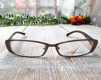 May include: Brown rectangular eyeglasses with clear lenses. The brand name "Bimarine" is visible on the right lens.