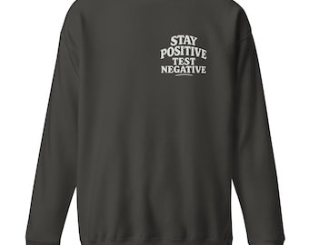 Blijf positief. Test negatief. – Premium uniseks sweater