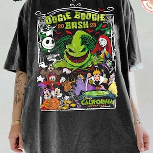 K&ouml;nnte beinhalten: Ein anthrazitfarbenes T-Shirt mit einem Grafikdruck mit dem Text Oogie Boogie Bash 25 und Disney California Adventure. Das Design enth&auml;lt Illustrationen verschiedener Zeichentrickfiguren, ein gr&uuml;nes Monster, einen K&uuml;rbis und Spinnennetze.
