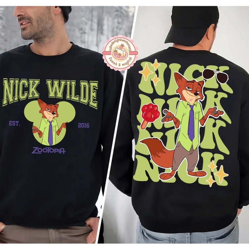 May include: Black sweatshirt featuring Nick Wilde from Zootopia. The front displays "Nick Wilde" in green lettering, with an image of Nick. The back has a larger Nick Wilde graphic with sunglasses and stars.