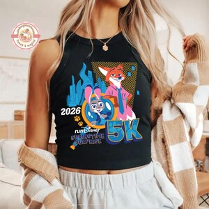 May include: Black vest top with a colourful graphic of Zootopia characters Judy Hopps and Nick Wilde, with the text "2026" and "5K". The design includes the words "runDisney Springtime Surprise".