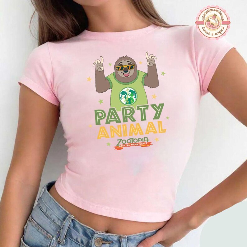 May include: A pale pink t-shirt with a cartoon sloth wearing sunglasses and a green shirt with a world map design. The text "PARTY ANIMAL" and "ZOOTOPIA" are printed on the shirt.