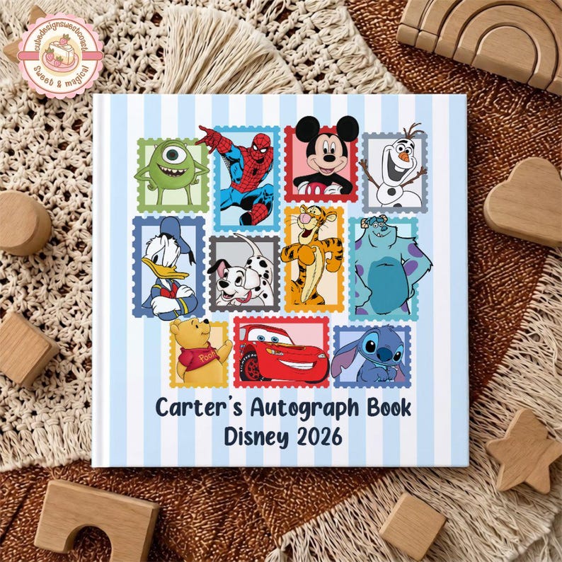May include: A square autograph book with a light blue and white striped background featuring various cartoon characters inside colorful postage stamp frames. The text reads Carter's Autograph Book Disney 2026 in dark blue lettering.