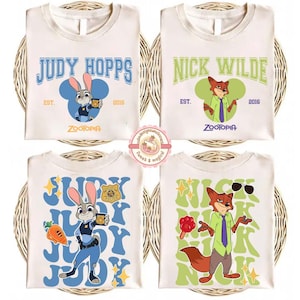 May include: Four white t-shirts with Zootopia character designs. Two shirts feature Judy Hopps, and two feature Nick Wilde. Each shirt has a different design, with the character's name and the year 2016.