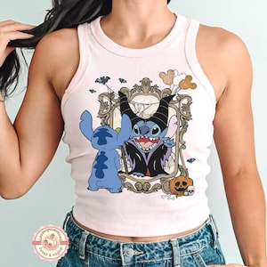 May include: Pale pink vest top with a Halloween-themed graphic. The design features Stitch and Maleficent characters, bats, a pumpkin, and Mickey Mouse balloons. The vest top has a white trim and a round logo at the bottom.