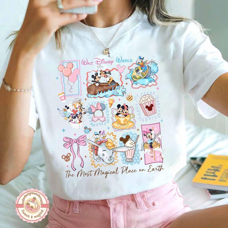 May include: White t-shirt featuring a colorful collage of Disney characters and icons, including Mickey and Minnie Mouse, Donald Duck, and Dumbo. The shirt has the text "Walt Disney World" and "The Most Magical Place on Earth."