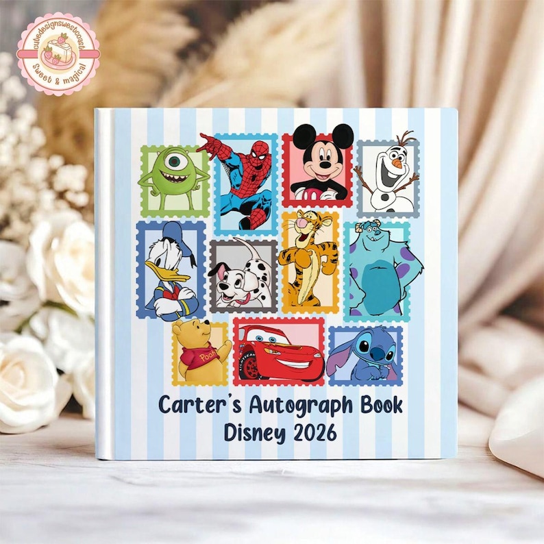 May include: A square autograph book with a light blue and white vertical striped cover. The front features various cartoon characters in colorful postage stamp frames, with the text Carter's Autograph Book Disney 2026 printed in black.