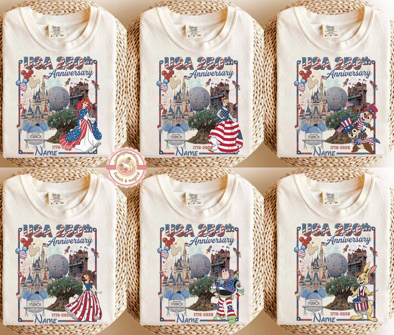 May include: Off-white t-shirts with a colorful graphic celebrating the USA's 250th Anniversary. Each shirt features a different cartoon character, the text "USA 250th Anniversary", and the years 1776-2026.