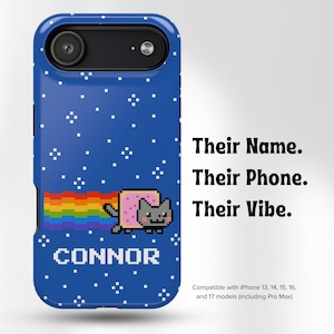 May include: Blue phone case with a pixelated design featuring a rainbow, a cat, and the name "CONNOR". The case also has the text "Their Name. Their Phone. Their Vibe."