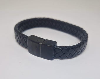 May include: A black leather bracelet with a braided design and a black metal clasp.