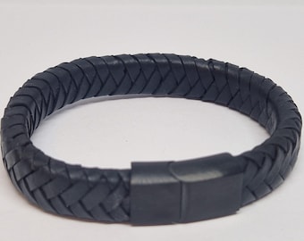 May include: A black leather bracelet with a braided design and a metal clasp.