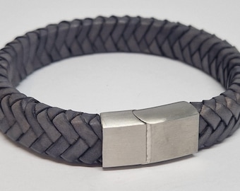May include: A grey braided leather bracelet with a silver magnetic clasp.