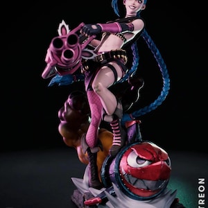May include: A detailed figurine of a character with blue hair, holding a large pink weapon. The figure is wearing a black and pink outfit and is standing on a bomb-shaped base. The base has a red face with a menacing grin. The image has the text "CA3D STUDIOS" and "PATREON".