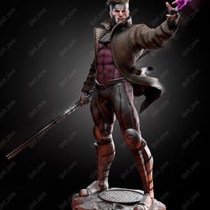 May include: A detailed 3D-printed figure of the Marvel Comics character Gambit, standing on a circular base. The figure is in a dynamic pose, with a staff in one hand and a glowing energy effect in the other. The figure is wearing a brown coat and a purple and black outfit. The text "3D VERSE STUDIOS" is visible.