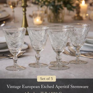 May include: Set of five vintage etched aperitif stemware glasses. Each glass is 4 inches tall and features an etched design. The glasses are from France or Bohemian origin and were made in the mid-20th century.