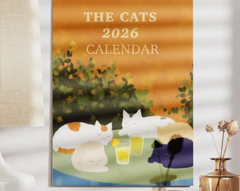 May include: A 2026 calendar titled "The Cats" features an illustration of three cats relaxing outdoors. One cat is white with orange spots, another is white, and the third is cream-colored. The scene includes drinks and a blue surface.
