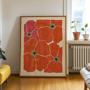May include: A rectangular framed wall art print featuring a stylized floral pattern with large, overlapping orange and pink poppy-like flowers. Each flower has a textured, scribbled appearance with a central dark, dotted circular stamen detail.