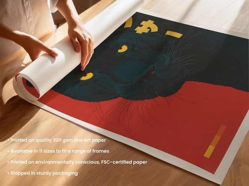 May include: A rolled art print featuring a stylized black panther with yellow eyes and gold accents against a red background. The print is being unrolled on a wooden surface. The print is on quality 200 gsm fine art paper.