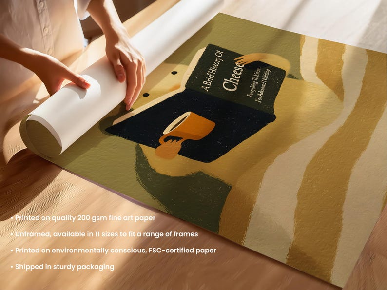 May include: Art print depicting a person reading "A Brief History of Cheese" with a cup. The print has a warm colour palette with a dark blue book and a yellow cup. The print is on fine art paper.