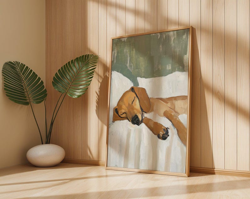 Peut inclure: Une peinture encadr&eacute;e d'un chien brun et blanc dormant sur un lit blanc. Le chien est enroul&eacute; sur le c&ocirc;t&eacute;, la t&ecirc;te reposant sur ses pattes. La peinture a un fond vert et est encadr&eacute;e dans un cadre en bois.