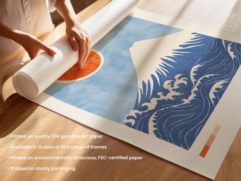 Close-up of Mount Fuji print being rolled for packaging, showing fine art paper texture, vivid red sun, and traditional Japanese wave design. High-quality Japanese poster printed on FSC-certified paper, ideal for framing.