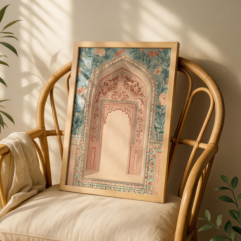 May include: A framed print featuring an arched doorway with intricate floral and geometric patterns in shades of red, blue, and beige. The artwork is set against a backdrop of floral designs and is displayed on a light-colored chair.