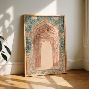 May include: A framed art print featuring an ornate archway design. The artwork showcases a detailed illustration with floral and geometric patterns in shades of teal, peach, and beige. The wooden frame complements the artwork's aesthetic.