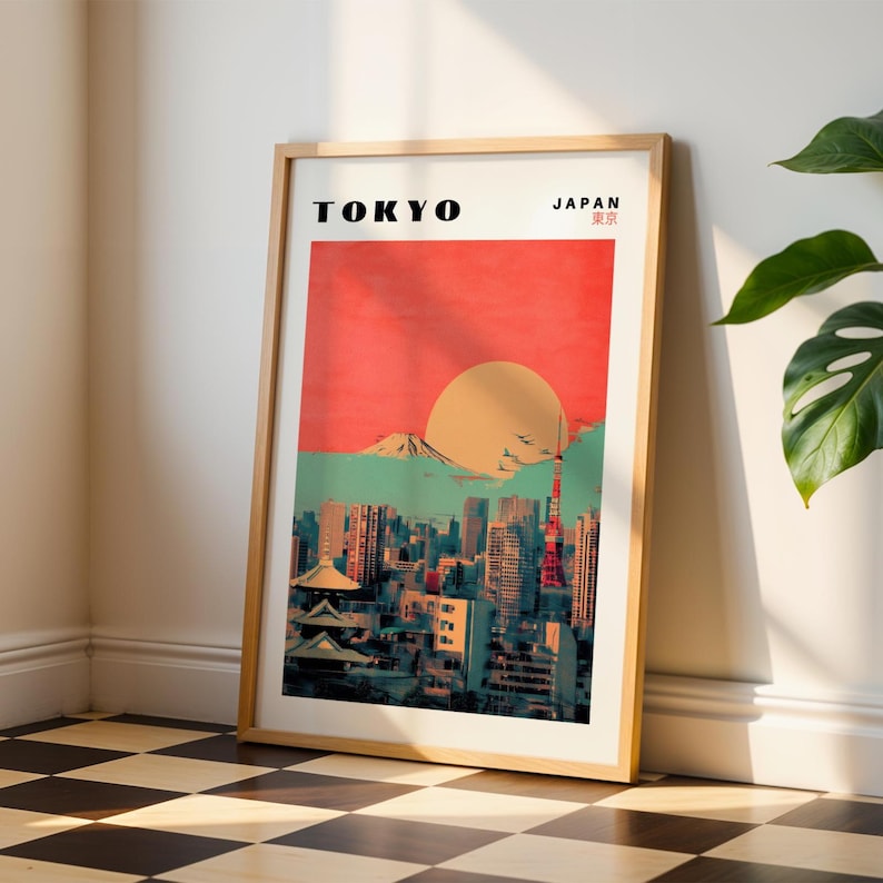 May include: A retro-style poster with a cityscape of Tokyo, Japan. The poster features a red and orange sunset over a mountain range, with the Tokyo Skytree and other buildings in the foreground. The text "TOKYO" and "JAPAN 東京" is printed in black at the top of the poster.