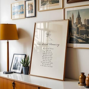 Framed Irish Blessing poem in warm-toned room with gallery wall – faith-based typography print for living room or hallway.